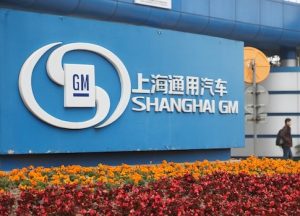 A man walks past thea Shanghai GM plant